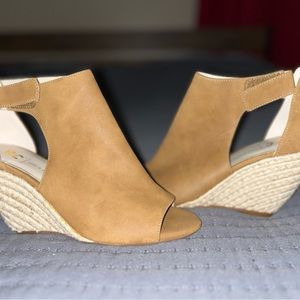Bought, never worn. Brand new size 7 straw wedges